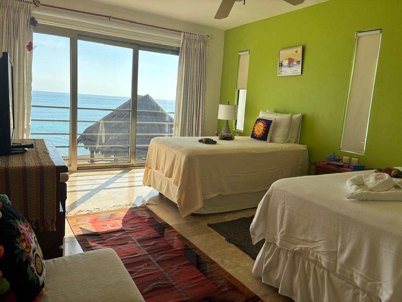 Habitación verde con balcón y mar